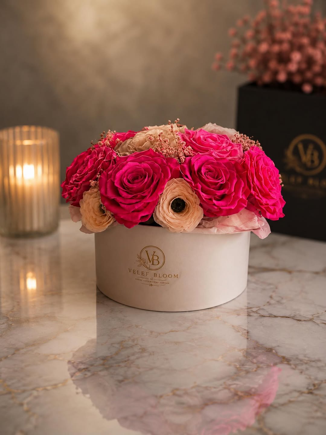 Grand arrangement of hot pink and champagne preserved roses spread across a wide white Velef Bloom ceramic bowl on marble