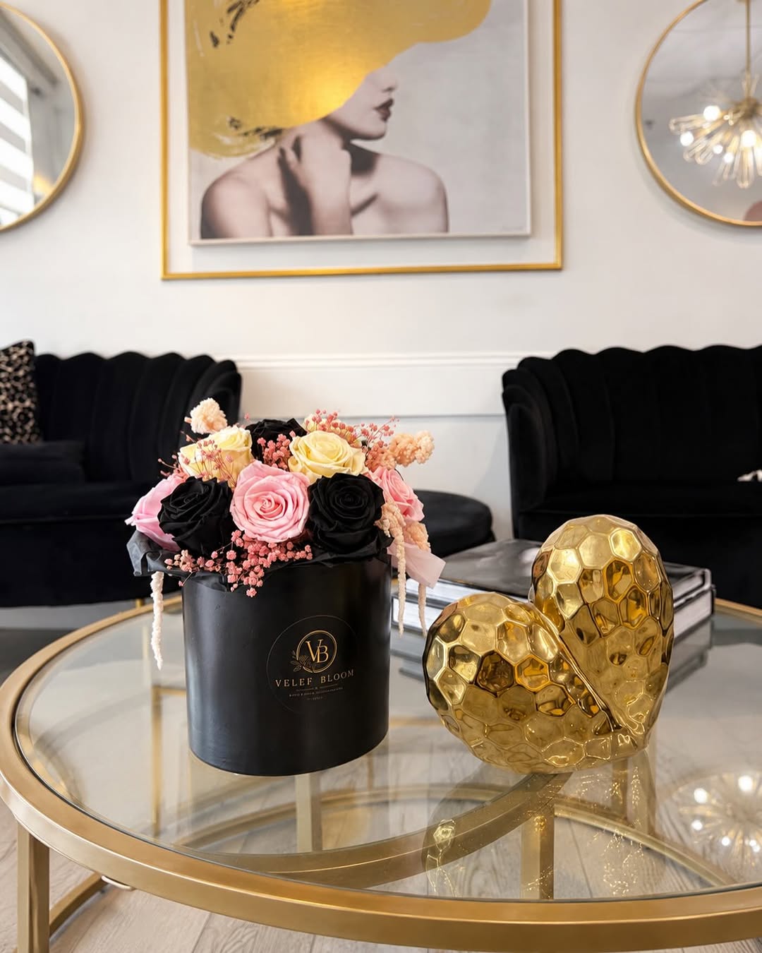 A black Velef Bloom arrangement of blush and cream preserved roses on a glass table at Blow & Go Parkland